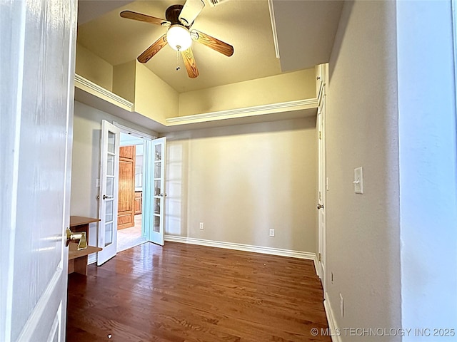 spare room with dark wood-type flooring, french doors, baseboards, and a ceiling fan