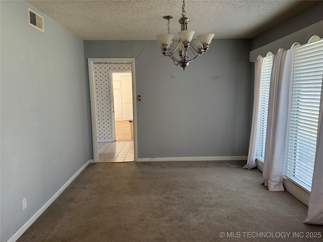 unfurnished dining area with a wealth of natural light, visible vents, a textured ceiling, and carpet flooring