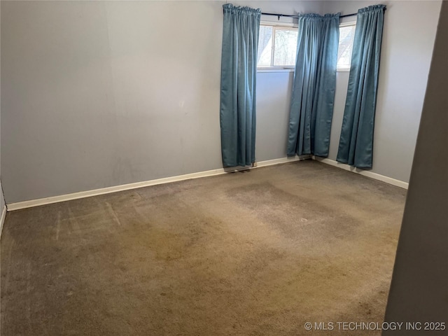 empty room with carpet and baseboards