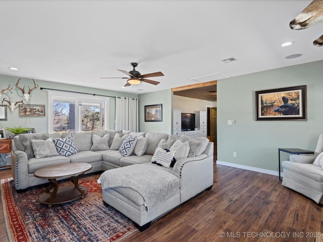 living room featuring a ceiling fan, visible vents, baseboards, dark wood finished floors, and recessed lighting