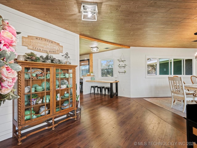 dining space with hardwood / wood-style flooring and wooden ceiling