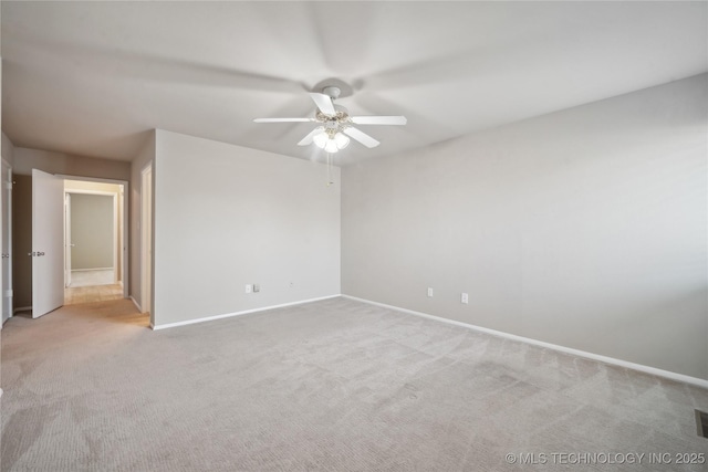 empty room featuring light carpet, a ceiling fan, and baseboards