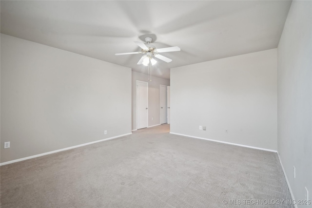 empty room featuring a ceiling fan, baseboards, and carpet floors