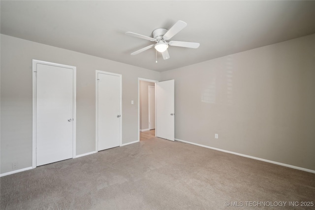 unfurnished bedroom with baseboards, light carpet, and a ceiling fan