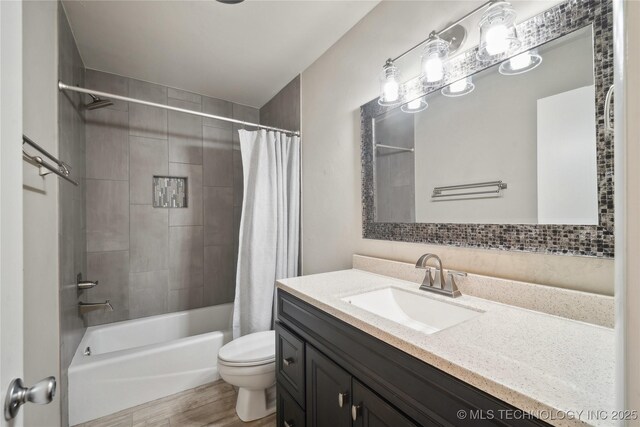 bathroom featuring vanity, toilet, shower / tub combo, and wood finished floors