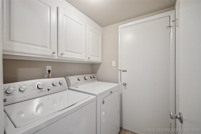 laundry room with washer and dryer and cabinet space
