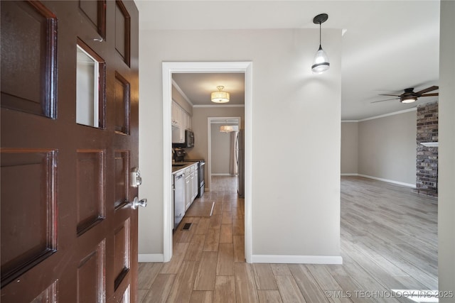 entrance foyer with visible vents, ceiling fan, crown molding, and light wood-style floors