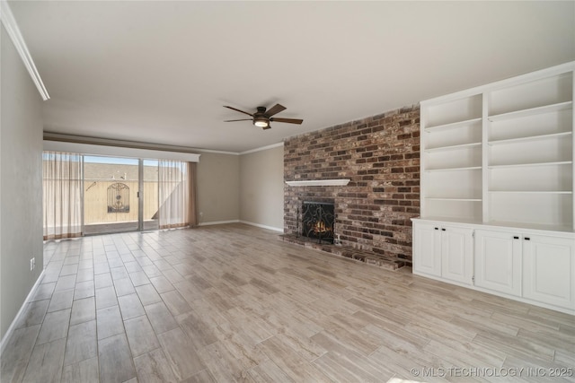 unfurnished living room with baseboards, a fireplace, ceiling fan, ornamental molding, and light wood-style floors