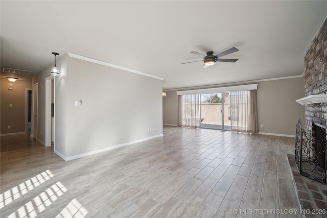 unfurnished living room with light wood-style flooring, ceiling fan, a fireplace, and crown molding