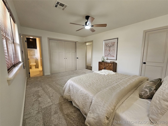 bedroom featuring carpet, visible vents, baseboards, ensuite bath, and a closet