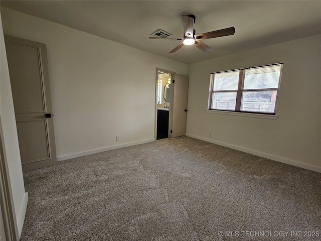 unfurnished bedroom featuring carpet flooring, visible vents, baseboards, and ceiling fan