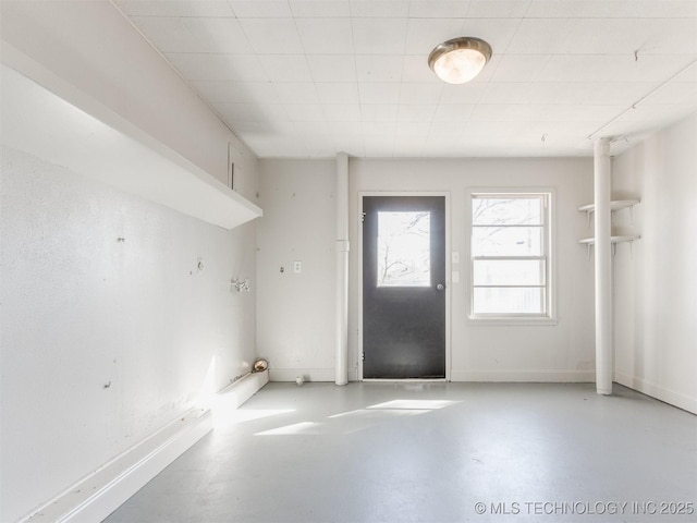 interior space featuring finished concrete flooring and baseboards