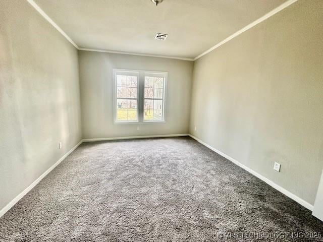 spare room featuring baseboards, carpet floors, and crown molding