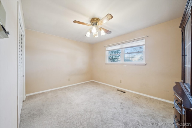 unfurnished bedroom featuring carpet floors, a closet, a ceiling fan, and baseboards