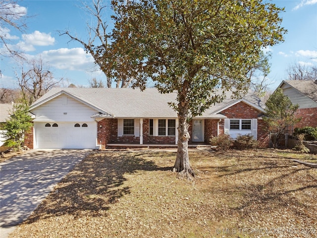 ranch-style house with driveway, brick siding, and an attached garage