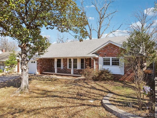 ranch-style home featuring an attached garage, driveway, roof with shingles, and brick siding