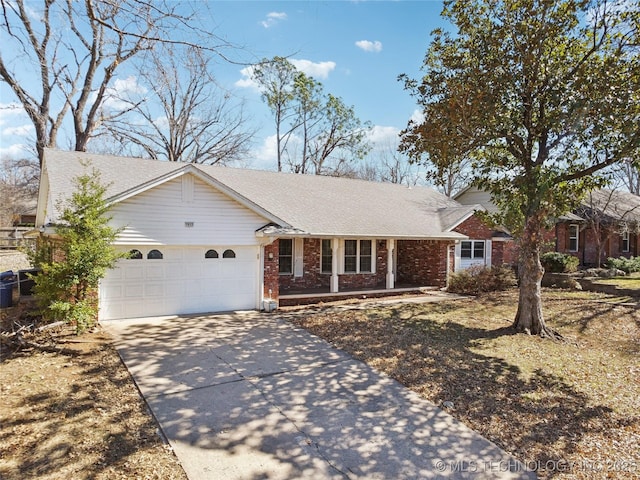 ranch-style home with an attached garage, covered porch, brick siding, driveway, and roof with shingles