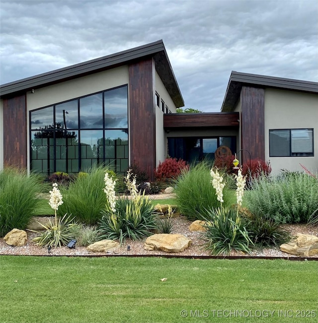 view of side of home featuring a yard