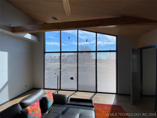 unfurnished living room with vaulted ceiling with beams, visible vents, and floor to ceiling windows