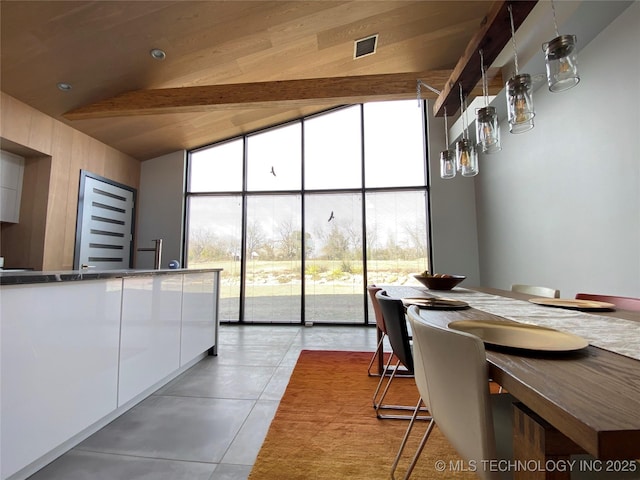 dining room featuring floor to ceiling windows, light tile patterned floors, lofted ceiling, visible vents, and wooden ceiling