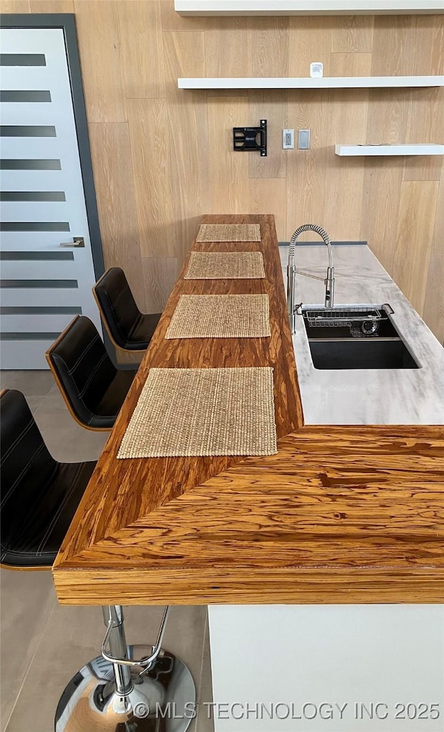 kitchen with a sink and open shelves