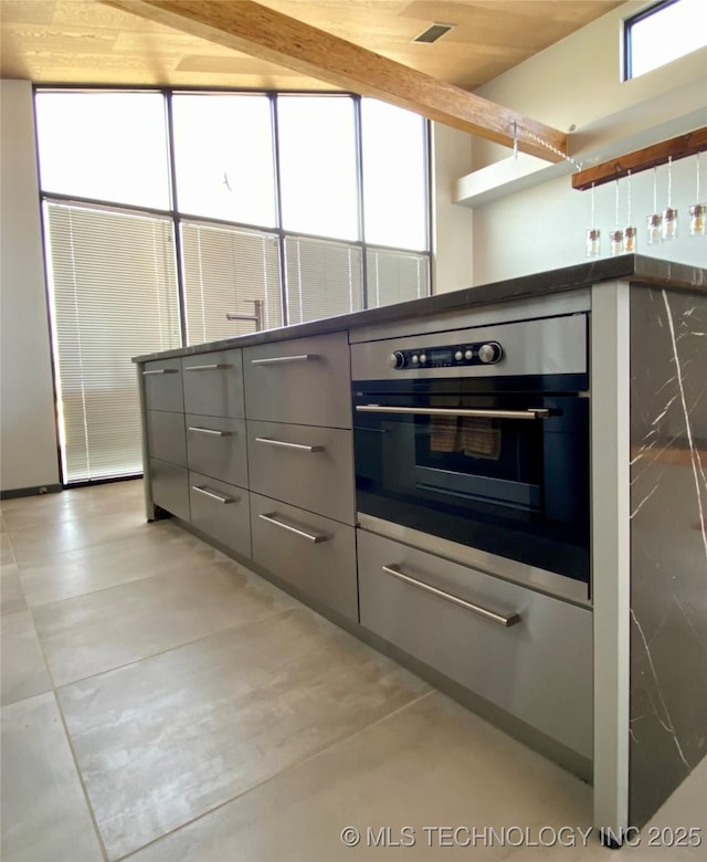 kitchen with gray cabinets, oven, visible vents, and modern cabinets