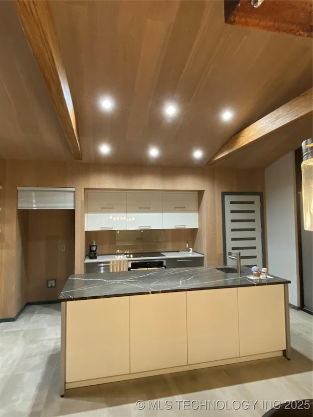 kitchen with dark countertops, recessed lighting, wall oven, a sink, and modern cabinets