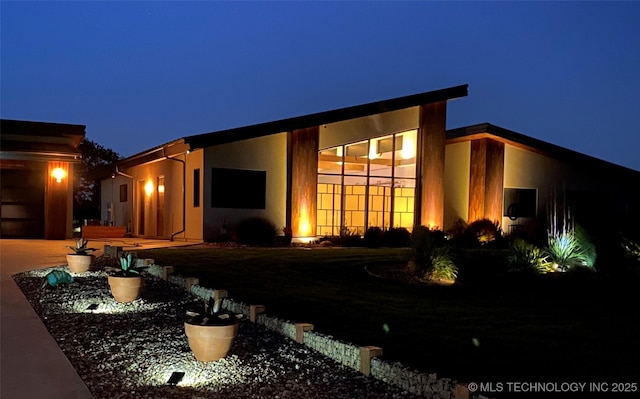 view of back of house at twilight