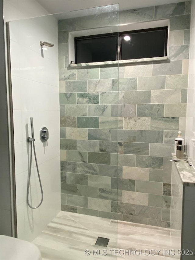 full bathroom with toilet and tiled shower