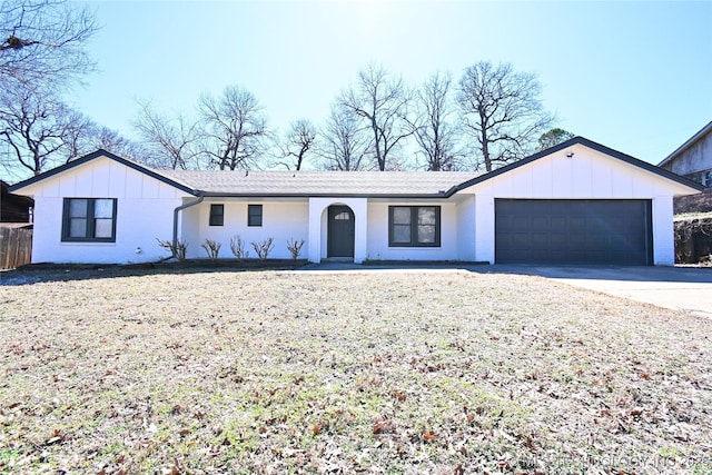 view of front of property with a garage, driveway, and board and batten siding