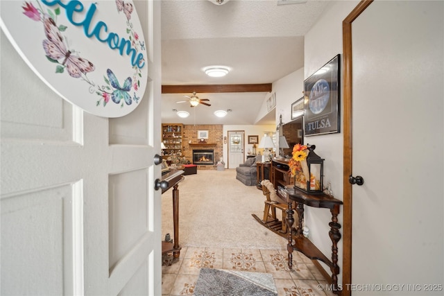 interior space featuring light tile patterned floors, light colored carpet, lofted ceiling with beams, and a textured ceiling