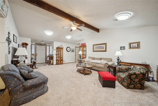 carpeted living area featuring ceiling fan, lofted ceiling with beams, visible vents, and a textured ceiling