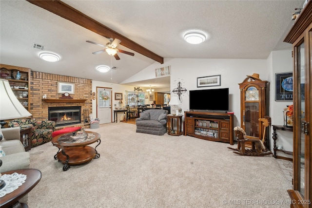 carpeted living area with a ceiling fan, visible vents, lofted ceiling with beams, a textured ceiling, and a brick fireplace