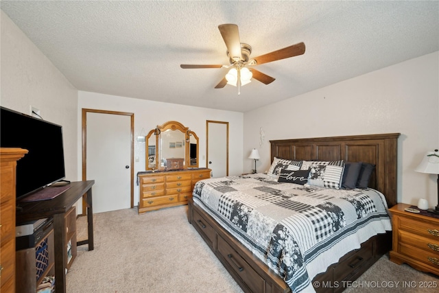 bedroom with light carpet, a textured ceiling, and ceiling fan