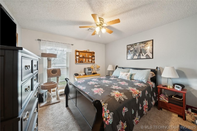 bedroom featuring a ceiling fan, visible vents, carpet floors, and a textured ceiling