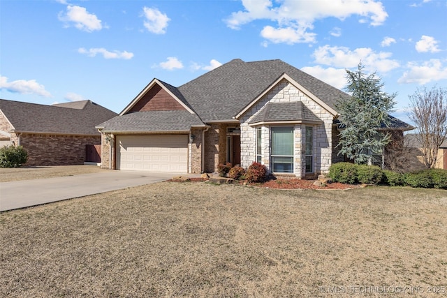 view of front facade featuring an attached garage, a shingled roof, concrete driveway, and brick siding