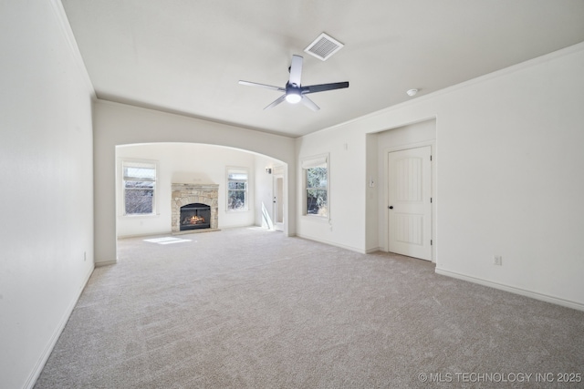 unfurnished living room with carpet, visible vents, and a wealth of natural light