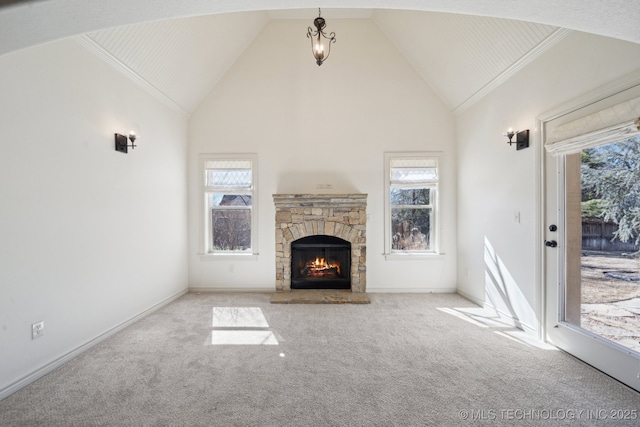 unfurnished living room featuring carpet floors, a fireplace, high vaulted ceiling, and baseboards