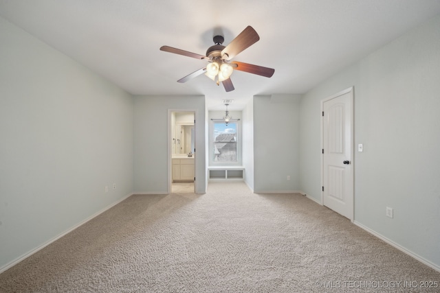 unfurnished bedroom featuring baseboards, ceiling fan, connected bathroom, and light colored carpet