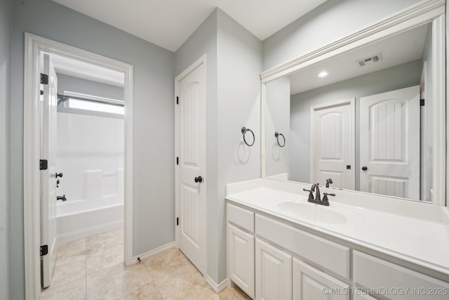 bathroom with shower / tub combination, tile patterned flooring, vanity, visible vents, and baseboards