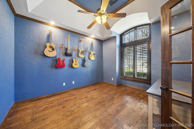 unfurnished room with a ceiling fan, ornamental molding, wood finished floors, and a textured wall