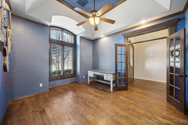 empty room featuring ornamental molding, french doors, visible vents, and wood finished floors