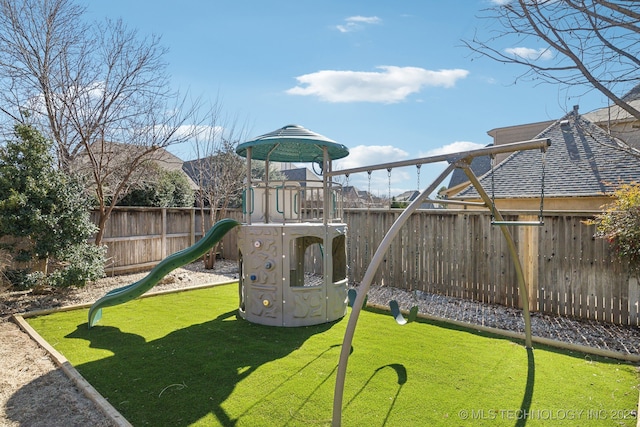 view of jungle gym with a yard and a fenced backyard