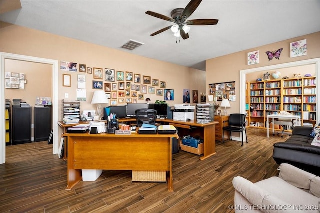 home office with ceiling fan, visible vents, and wood finished floors