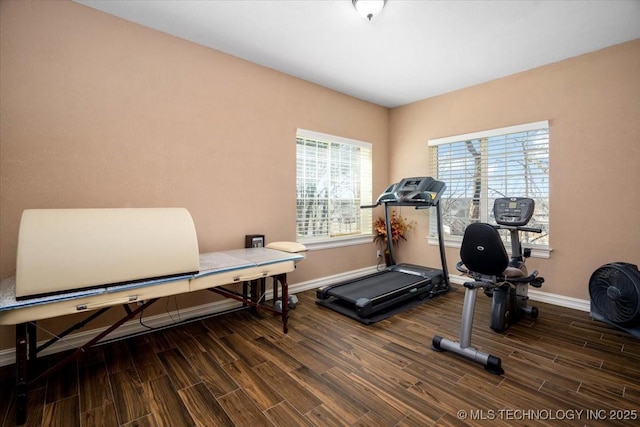 exercise room with wood tiled floor and baseboards