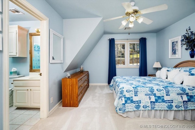 bedroom featuring ensuite bath, visible vents, and baseboards