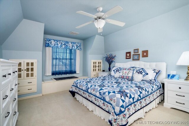 bedroom with a ceiling fan, carpet, visible vents, and vaulted ceiling