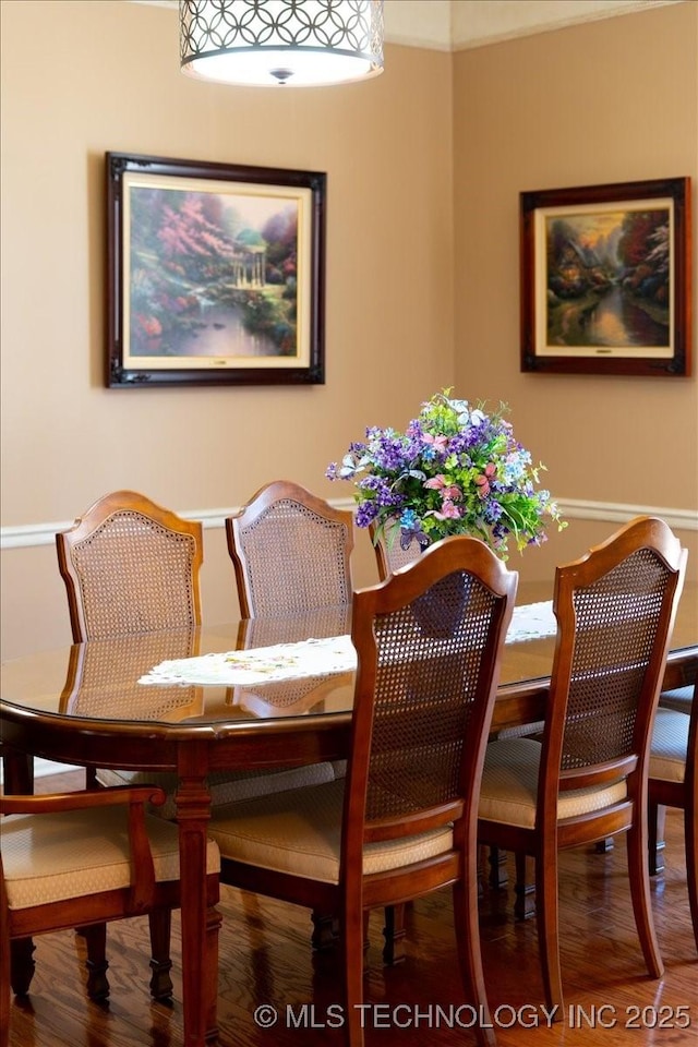 dining space with wood finished floors