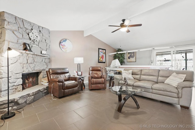 tiled living room with vaulted ceiling with beams, ceiling fan, and a stone fireplace