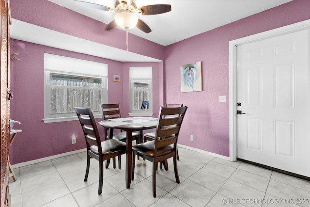 dining room with baseboards, a ceiling fan, and light tile patterned flooring